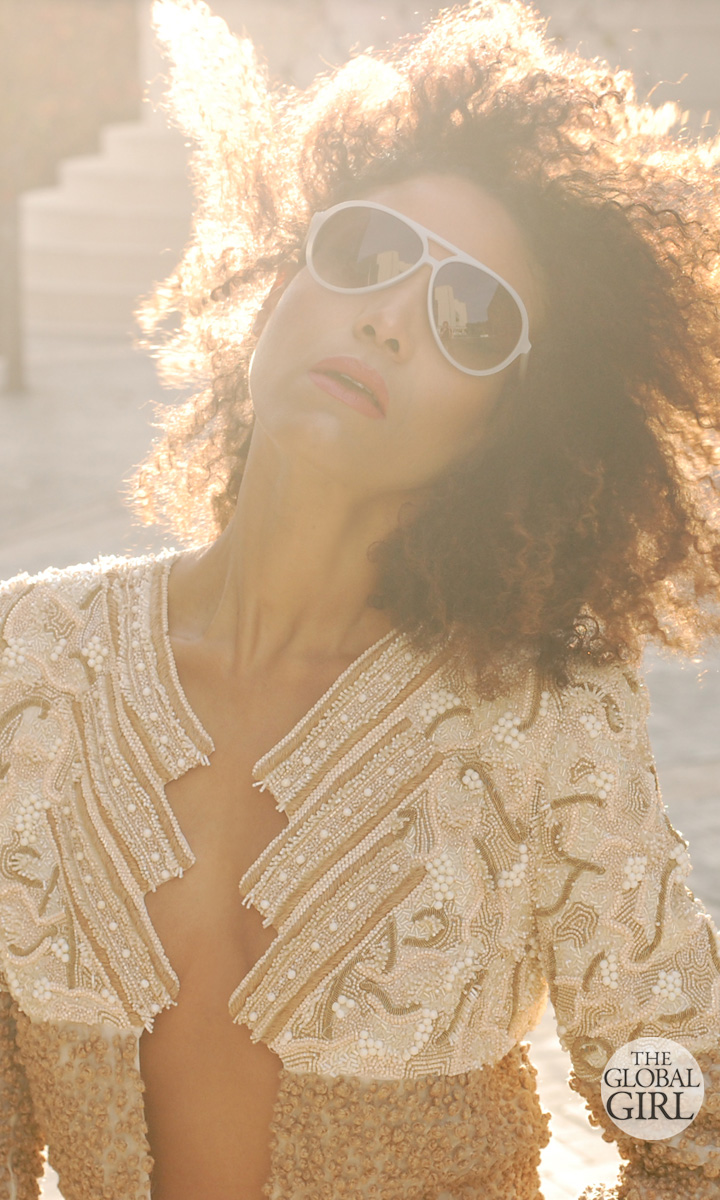The Global Girl Fashion Editorials: Ndoema sports a beaded tuxedo stripe pants with matching jacket ensemble by Mimi Plange. Vintage suede clutch bag. Beige suede platform stilettos by Betsey Johnson. Aviator sunglasses by Matthew Williamson.
