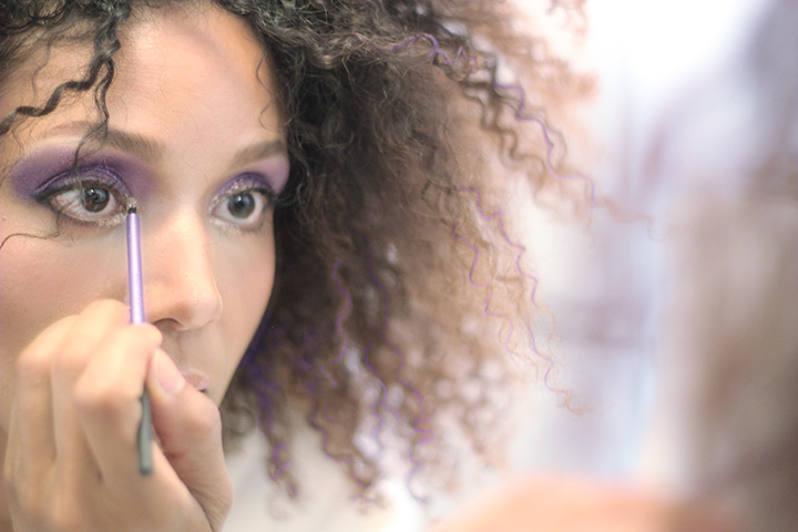 Ndoema rocks her trademark curly hair styled with Garnier Color Styler in Purple Mania, in a 