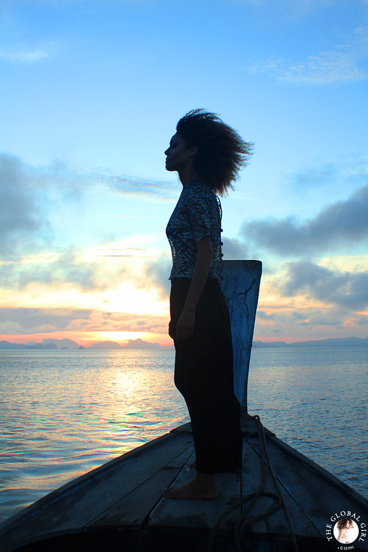 The Global Girl Travels: Ndoema takes in the sunrise on a traditional thai long boat in the Andaman Sea.