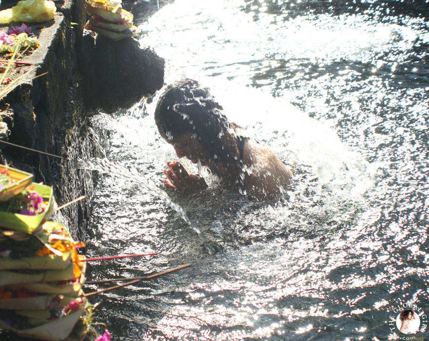 The Global Girl Travels: Ndoema bathing in holy spring water at the Tirta Empul Temple in Bali, Indonesia.